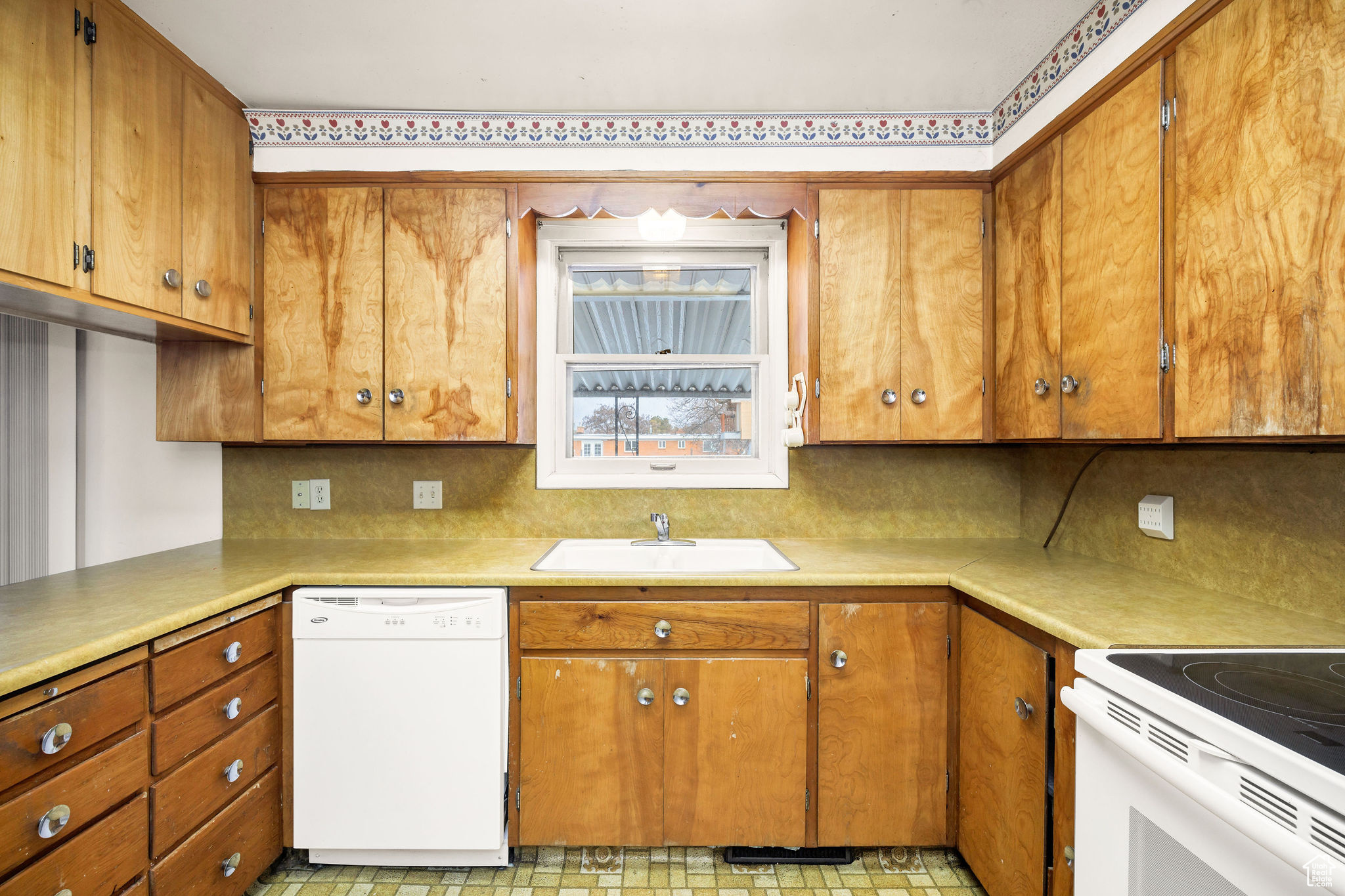 Kitchen with white appliances and sink