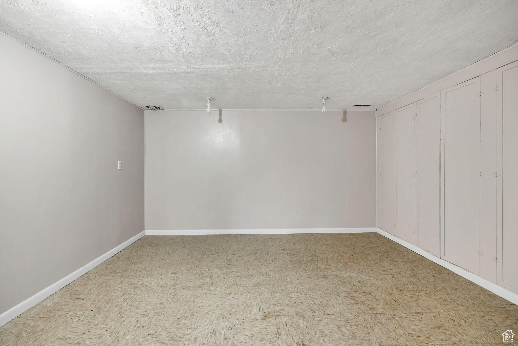 Basement featuring a textured ceiling