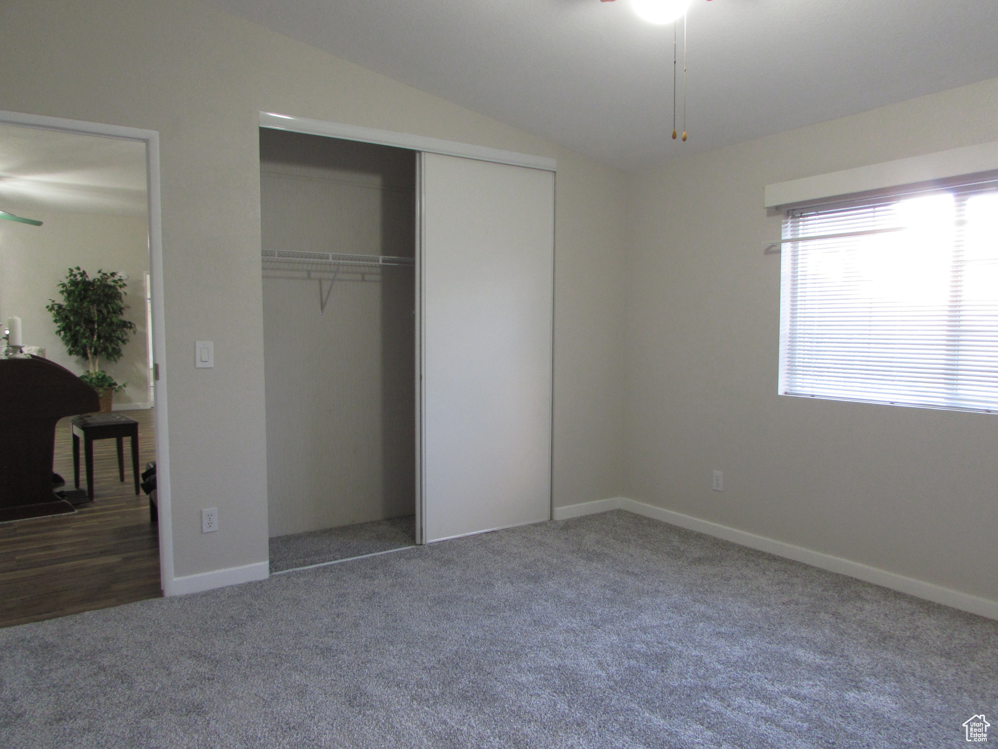 Bedroom #2 featuring new carpet, lofted ceiling, and a closet