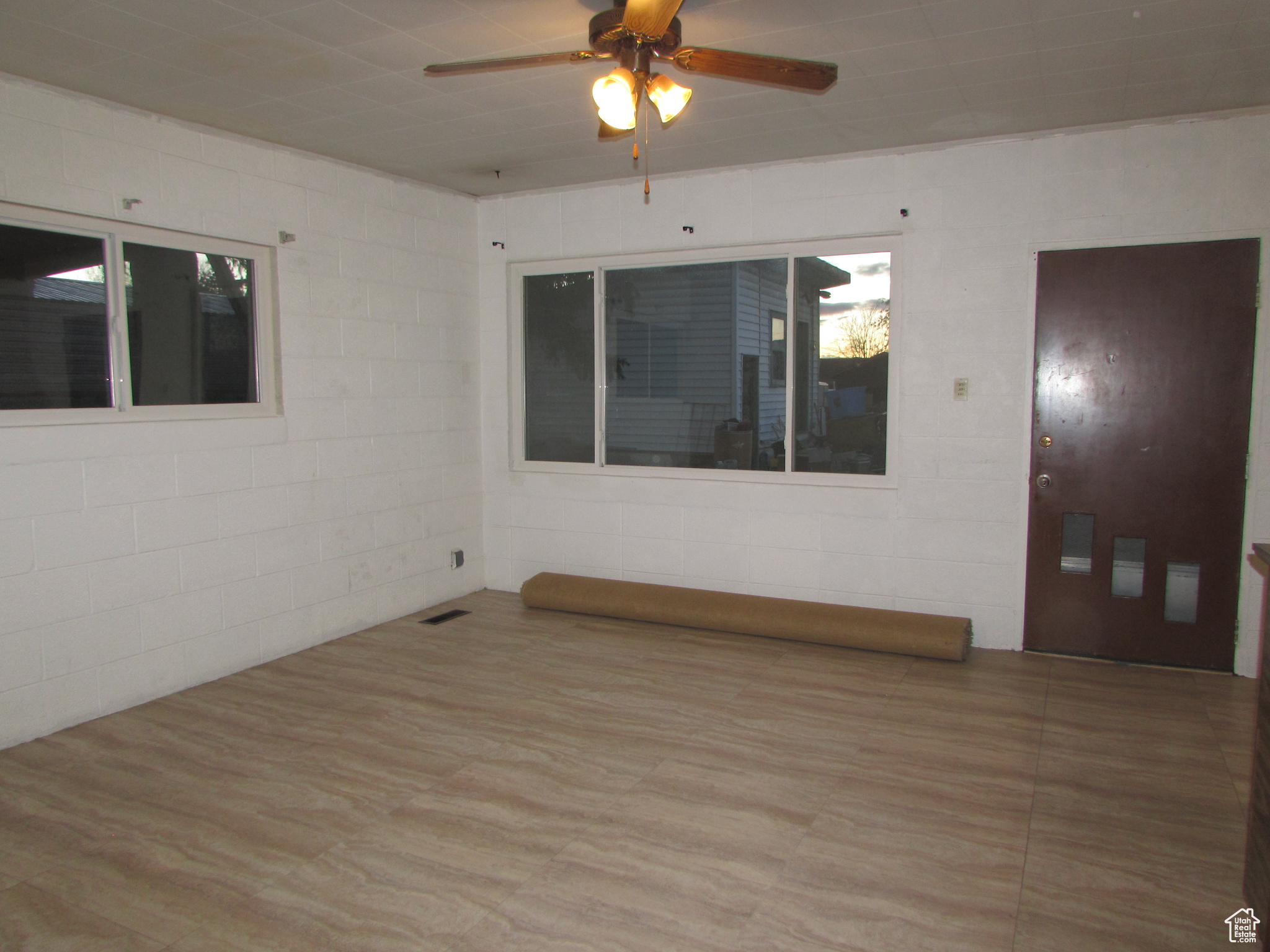 Apartment - Living room with ceiling fan and light tile wood-style floors