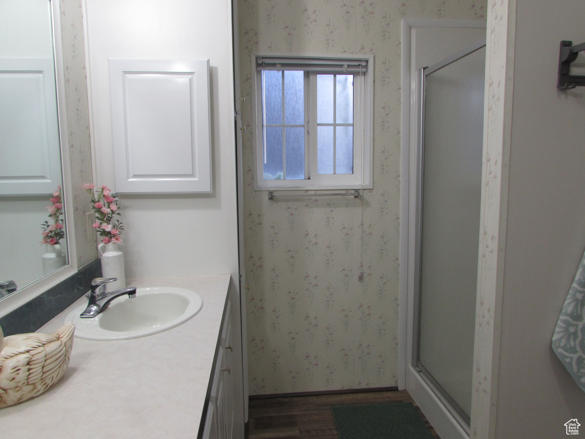 Master Bathroom with hardwood / wood-style flooring, vanity, and walk in shower