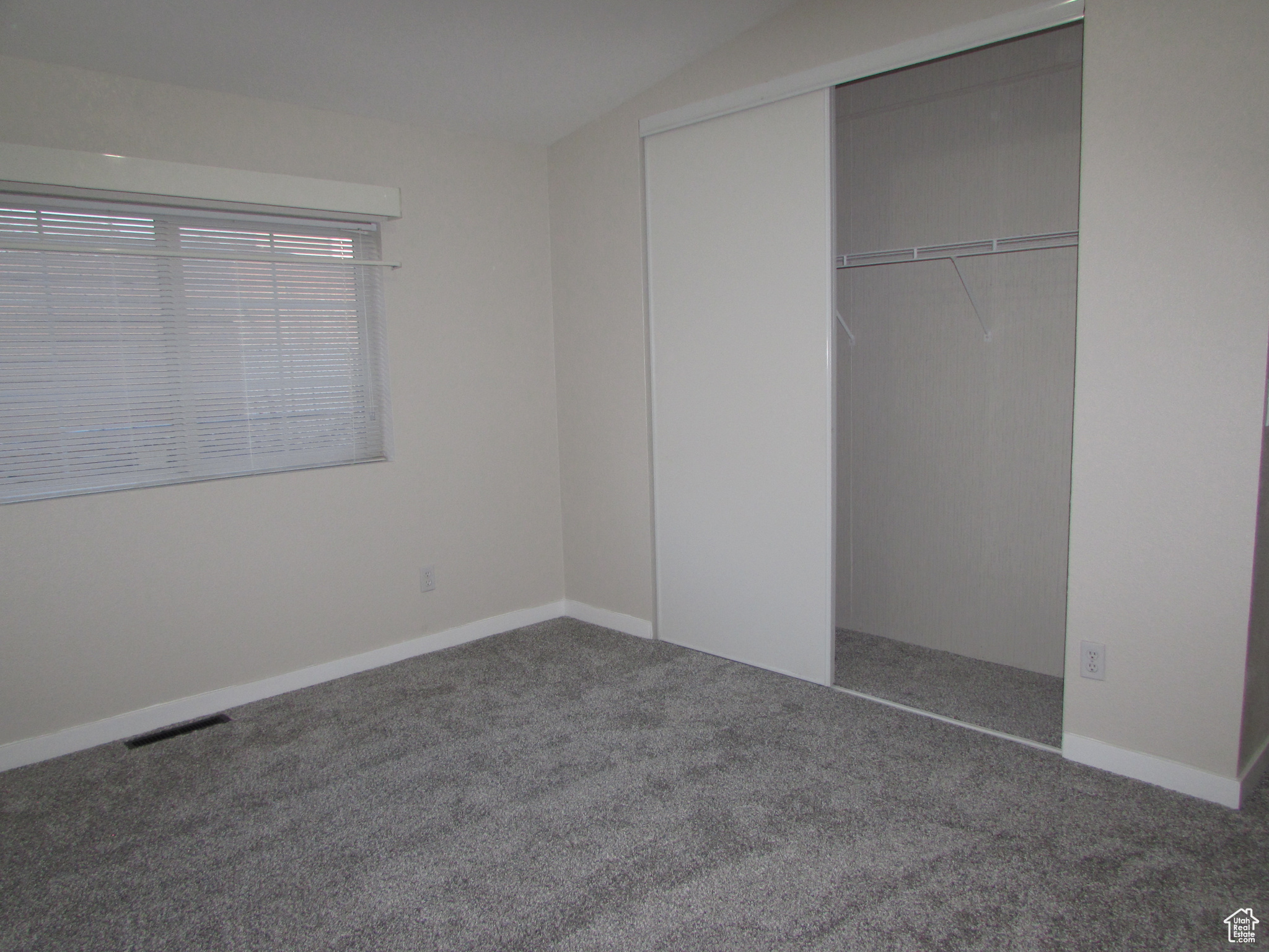 Bedroom #3 featuring new carpet and paint, and a closet