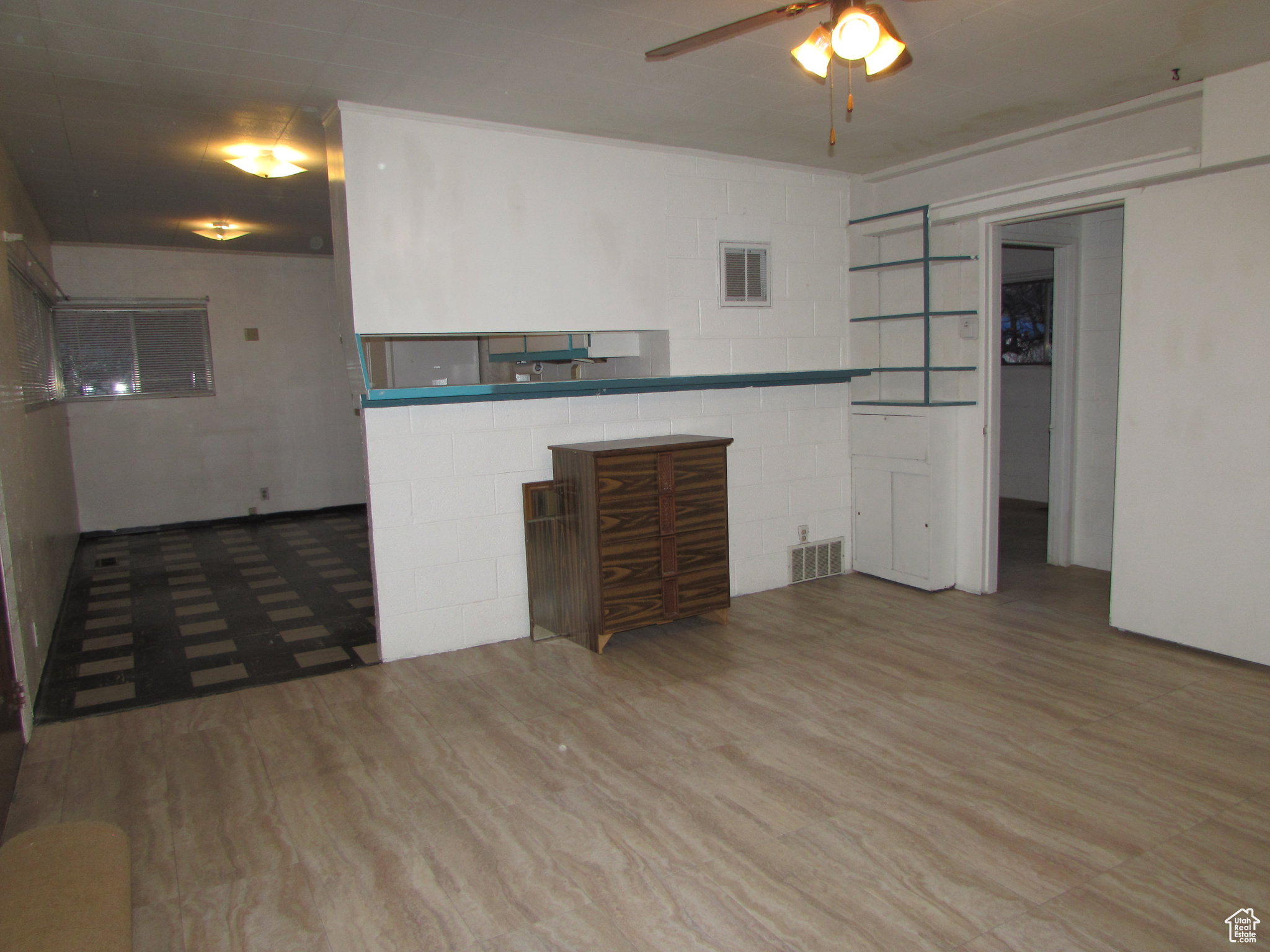 Apartment - living room featuring built-in shelving, tile wood-style floors, and ceiling fan