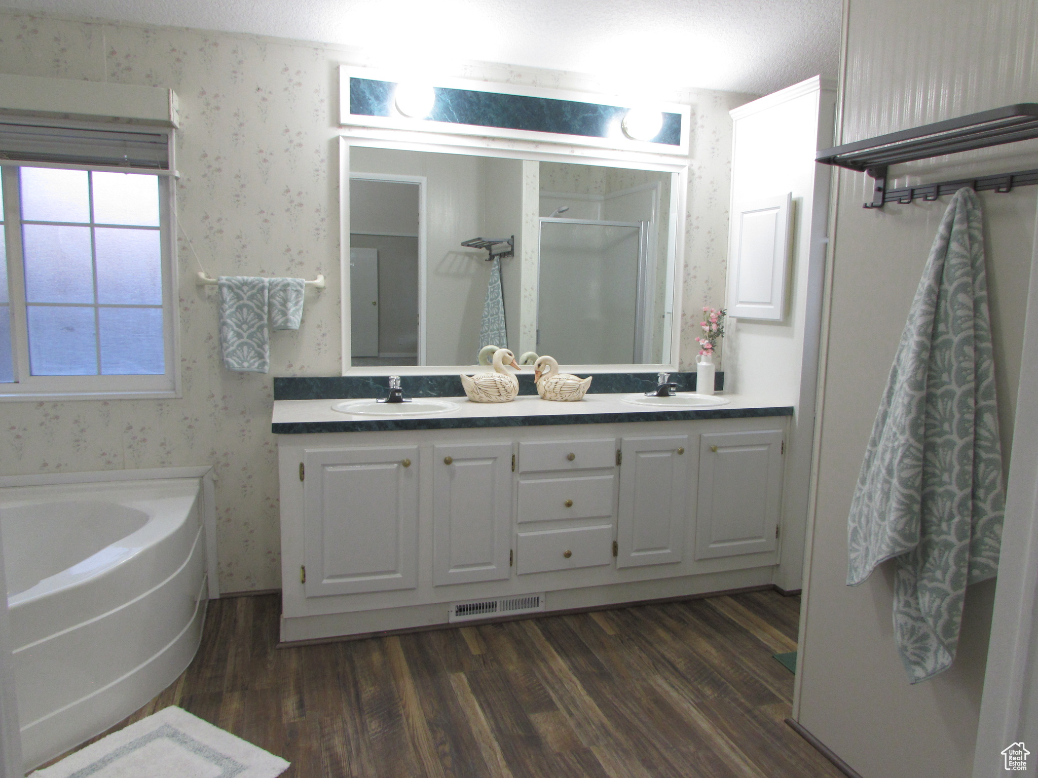 Master Bathroom with vanity, separate shower and tub, and wood-type flooring