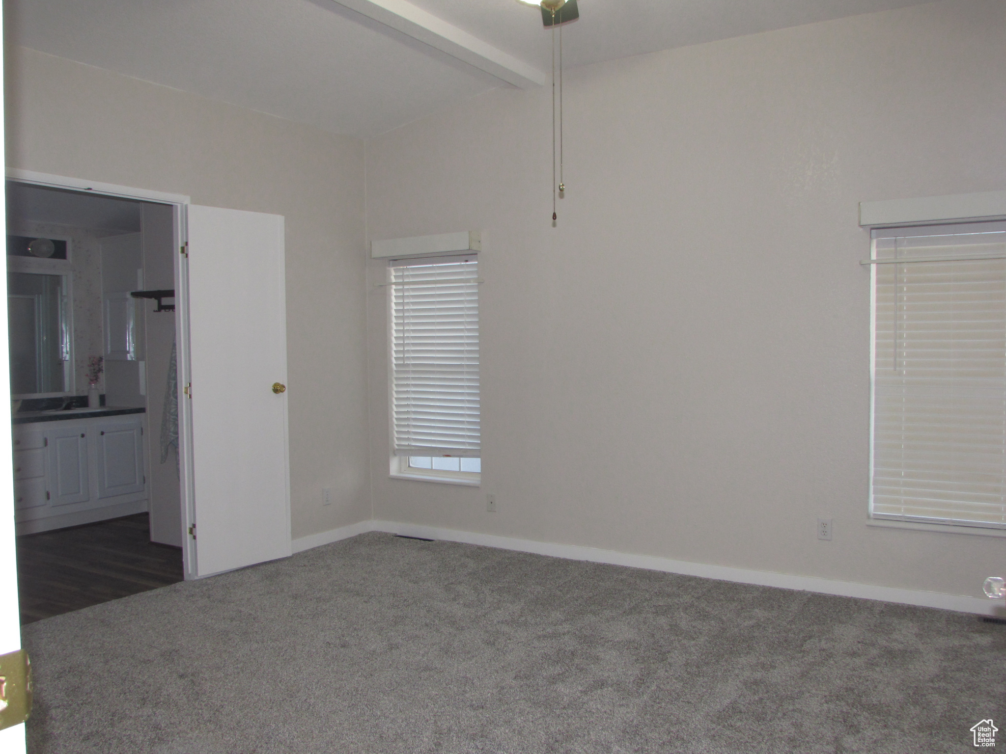 Master bedroom with ceiling fan and new carpet