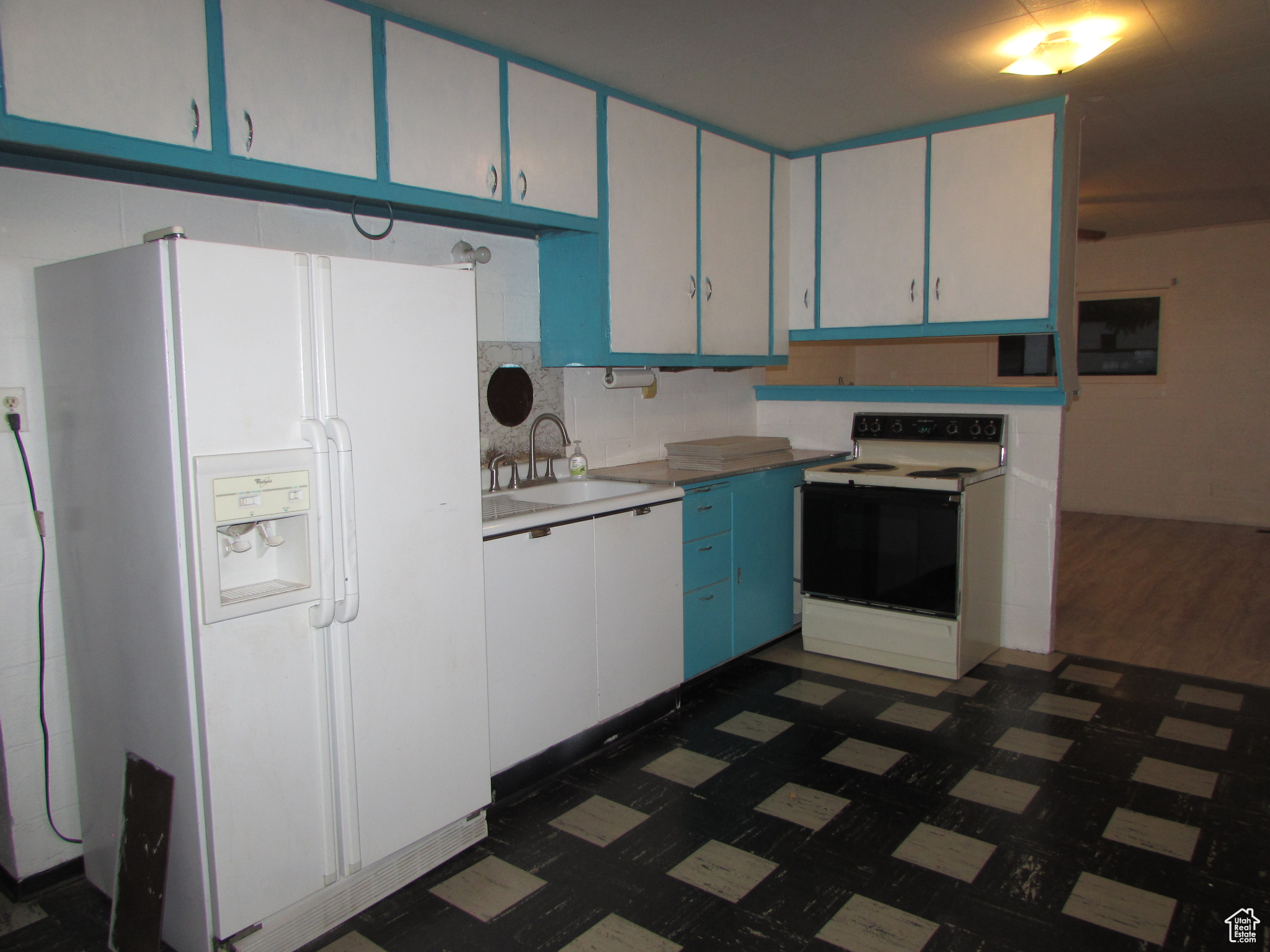 Apartment - Kitchen featuring blue cabinetry, white appliances, and sink