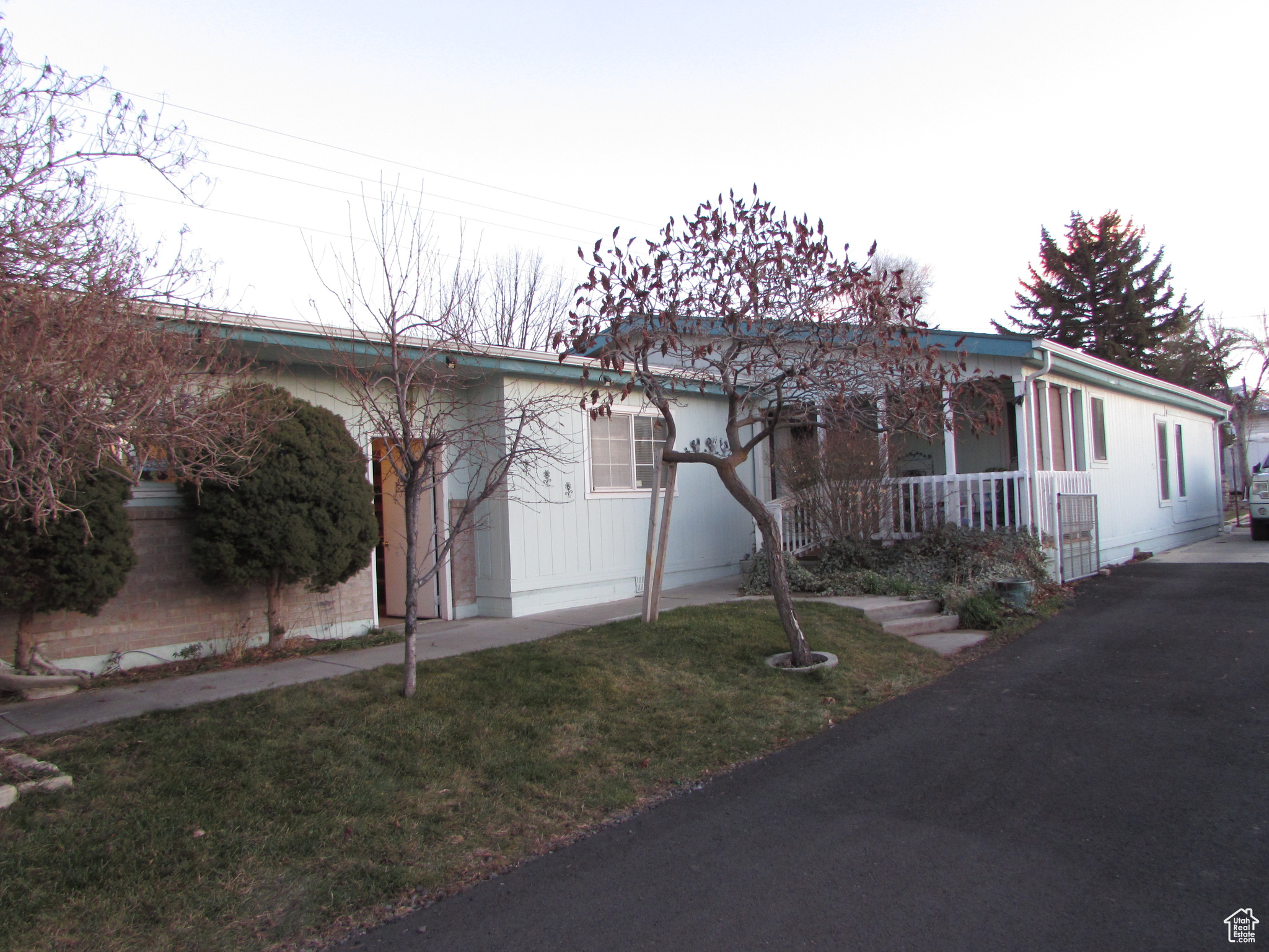 View of front of property with covered porch and a front yard