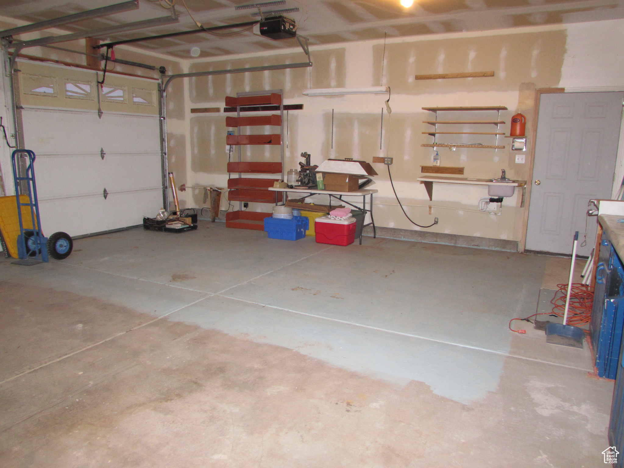 Garage with a garage door opener & extra storage