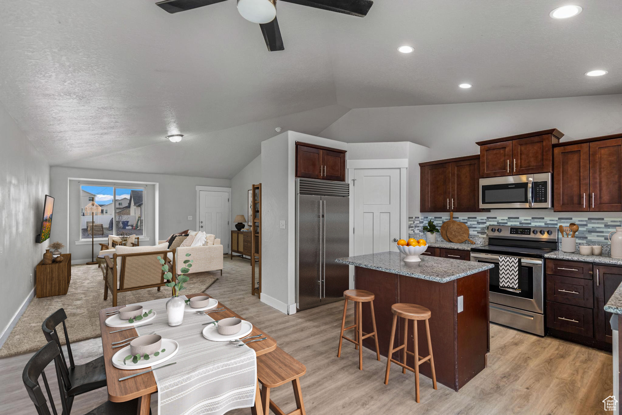 Spacious Kitchen with a large Island, Granite Countertops, and Soft-pull Cabinets.