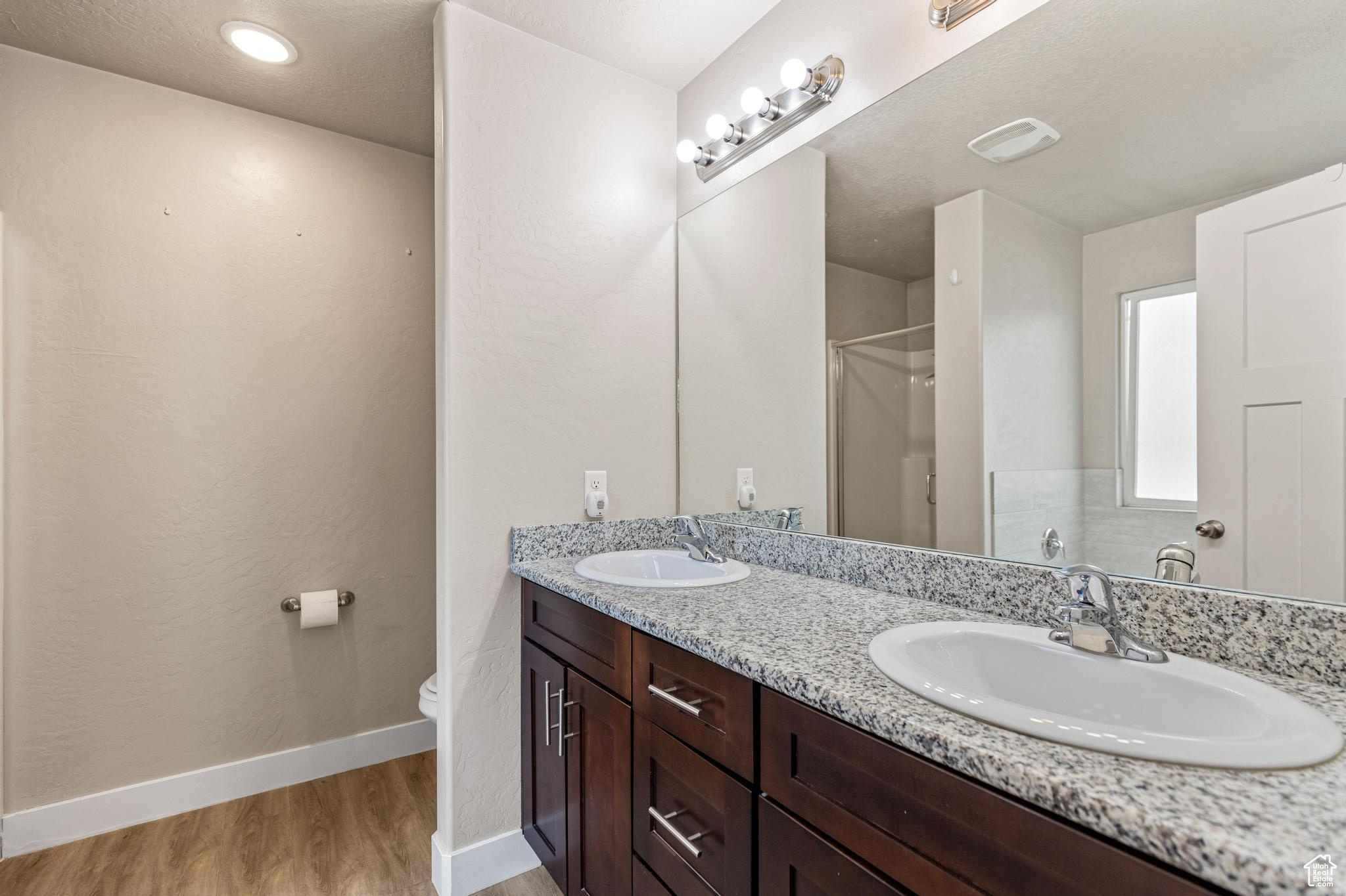 Ensuite bathroom with double vanity, and both a soaking tub and an enclosed shower.