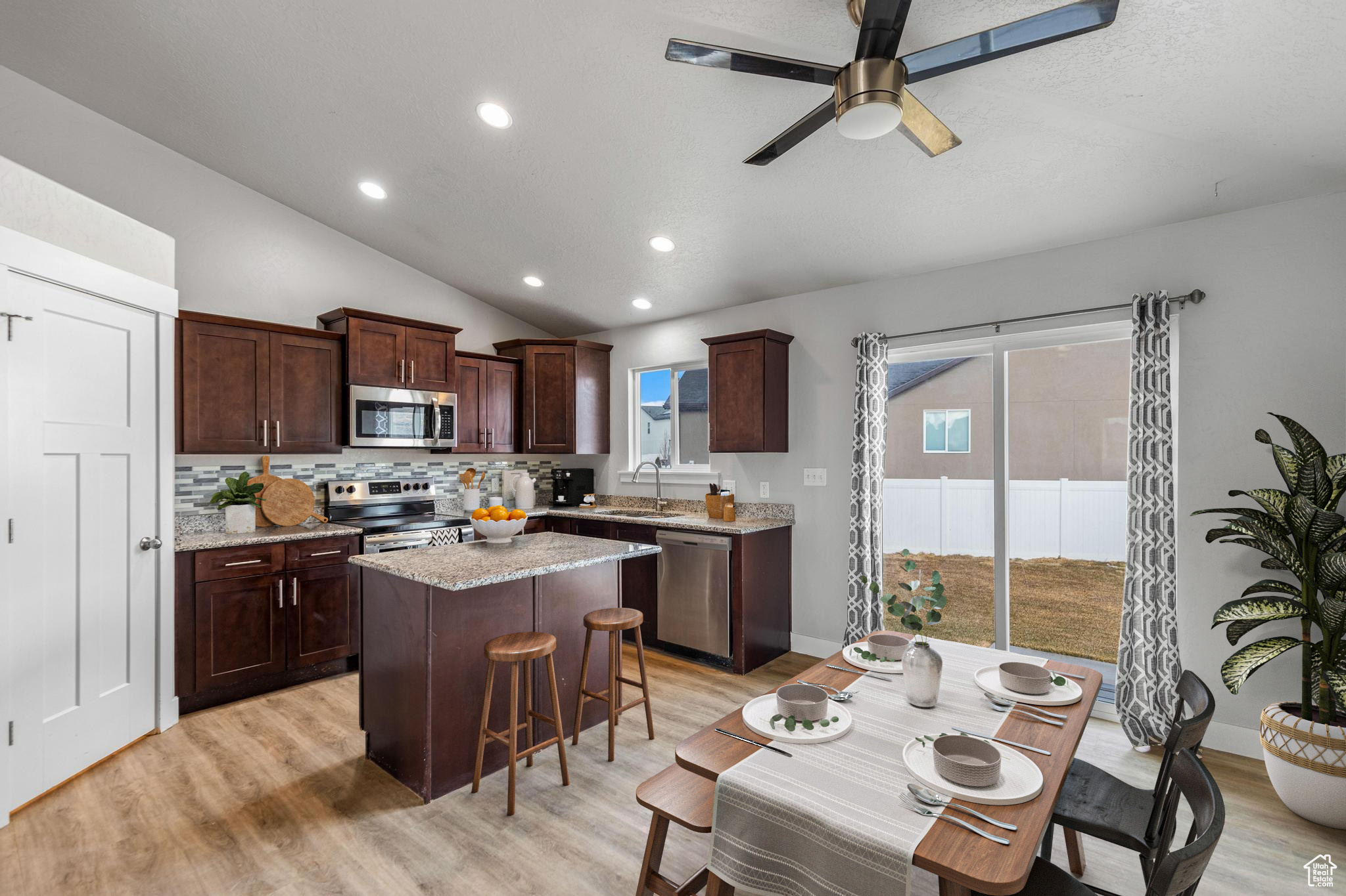 Spacious Kitchen with a large Island, Granite Countertops, and Soft-pull Cabinets.