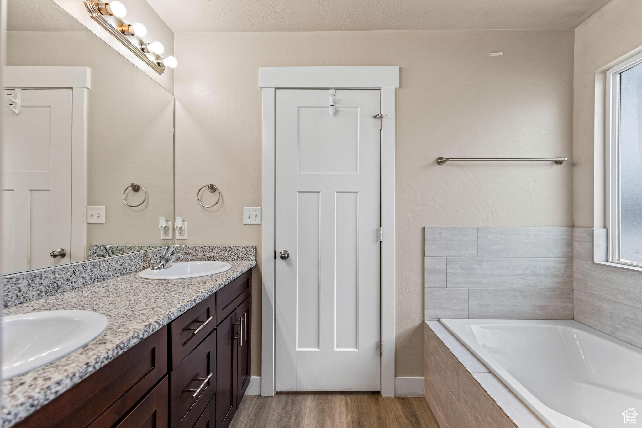 Ensuite bathroom with double vanity, and both a soaking tub and an enclosed shower.