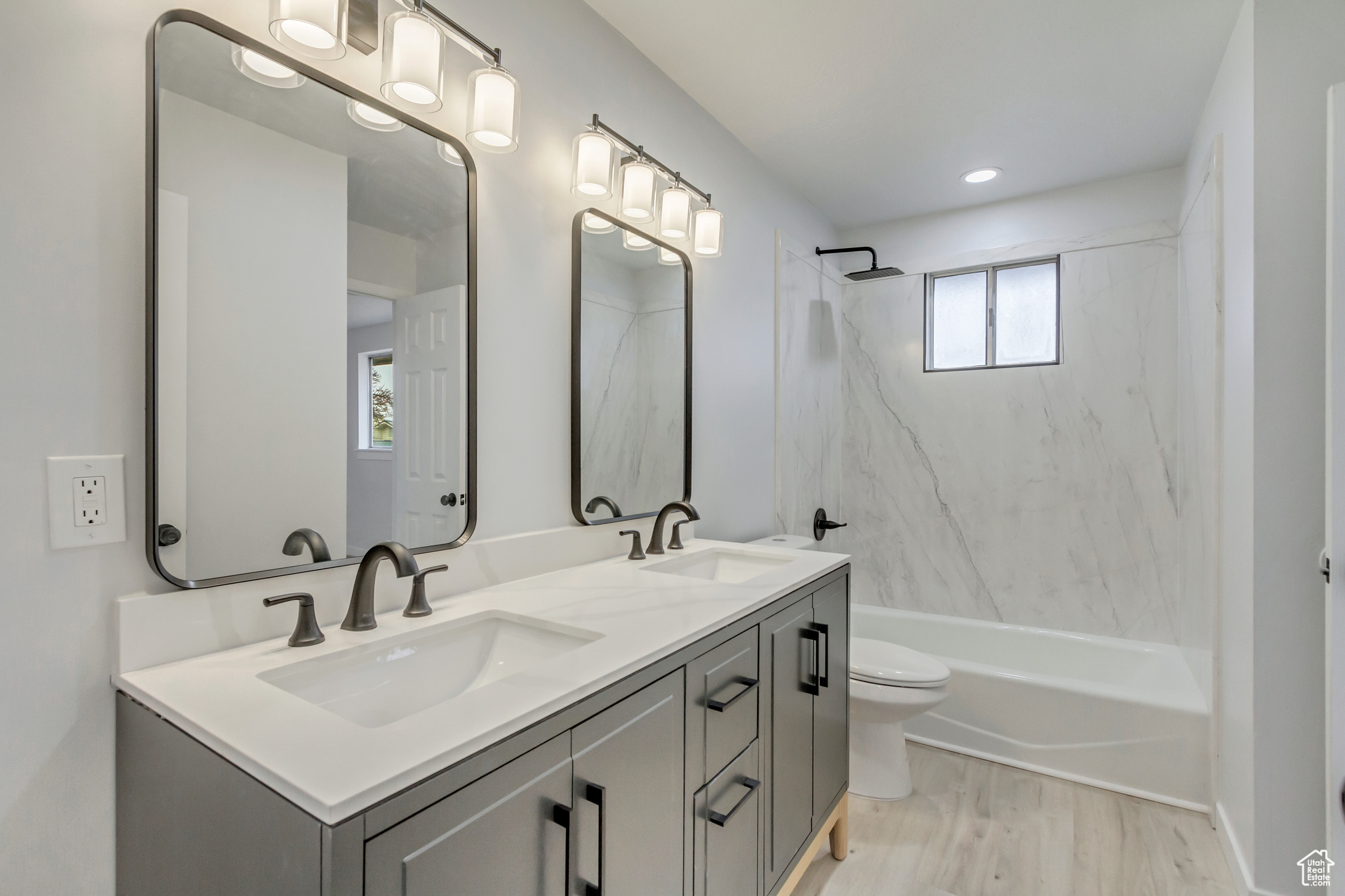 Full bathroom with shower / bathing tub combination, vanity, toilet, and wood-type flooring