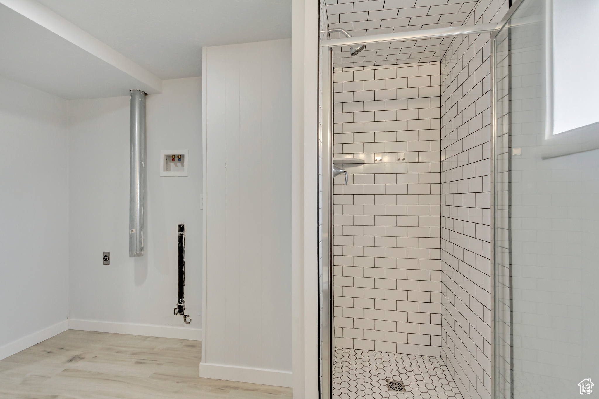 Bathroom with wood-type flooring and an enclosed shower