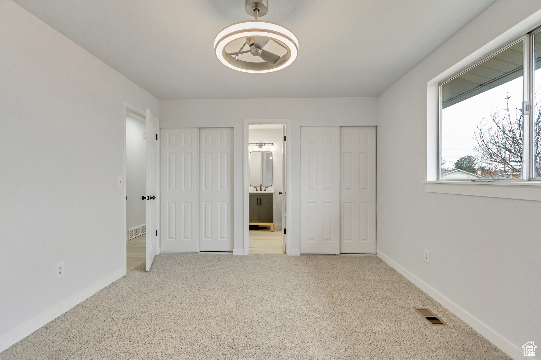 Unfurnished bedroom featuring carpet flooring and ensuite bathroom