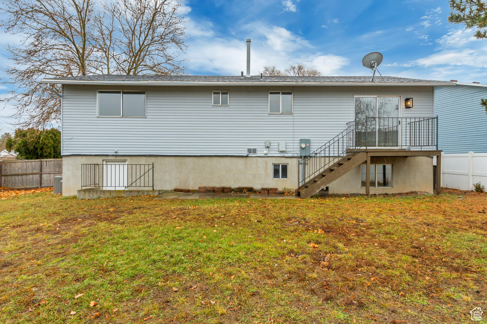 Back of property featuring a lawn