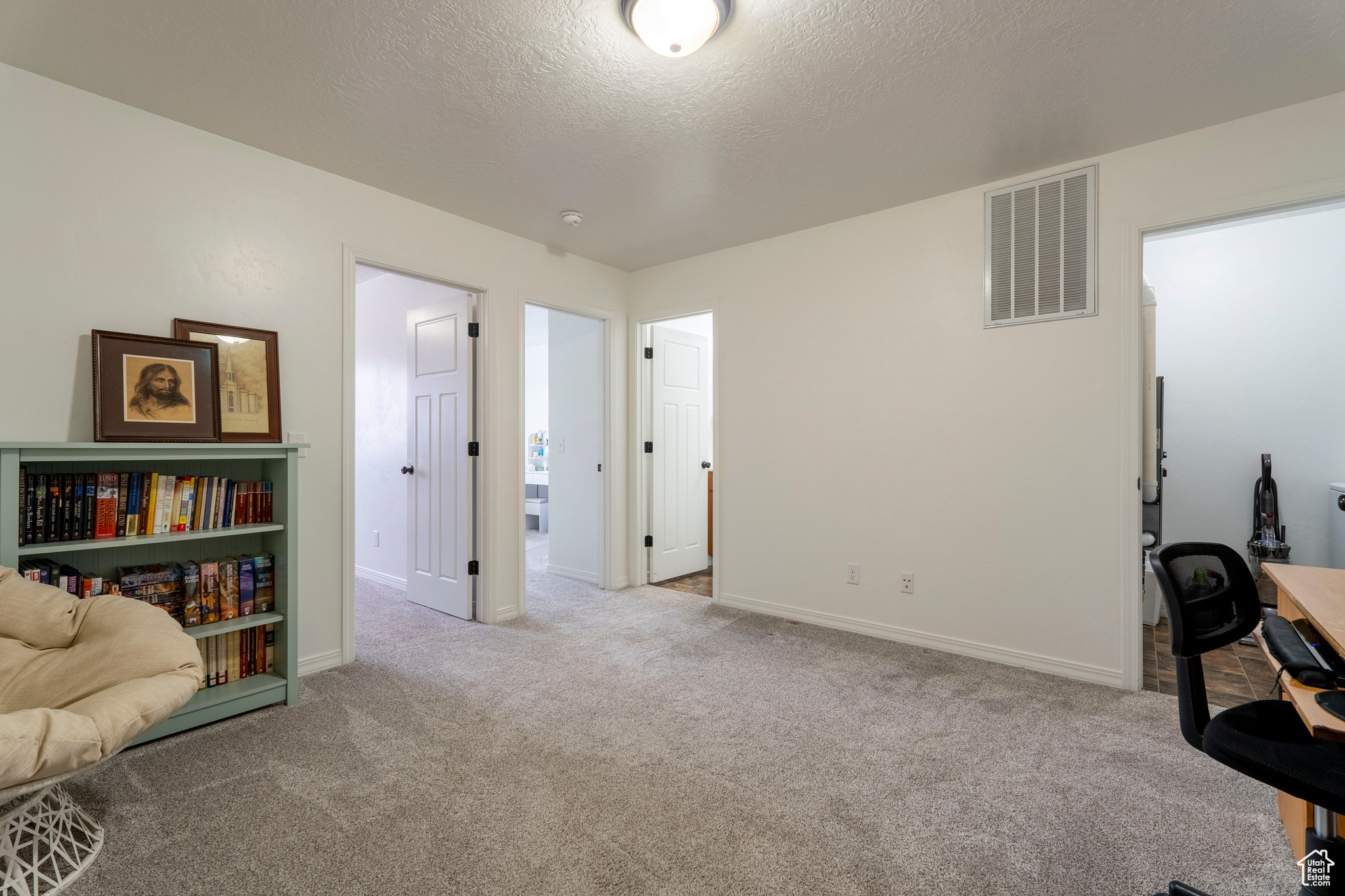 Carpeted office with a textured ceiling