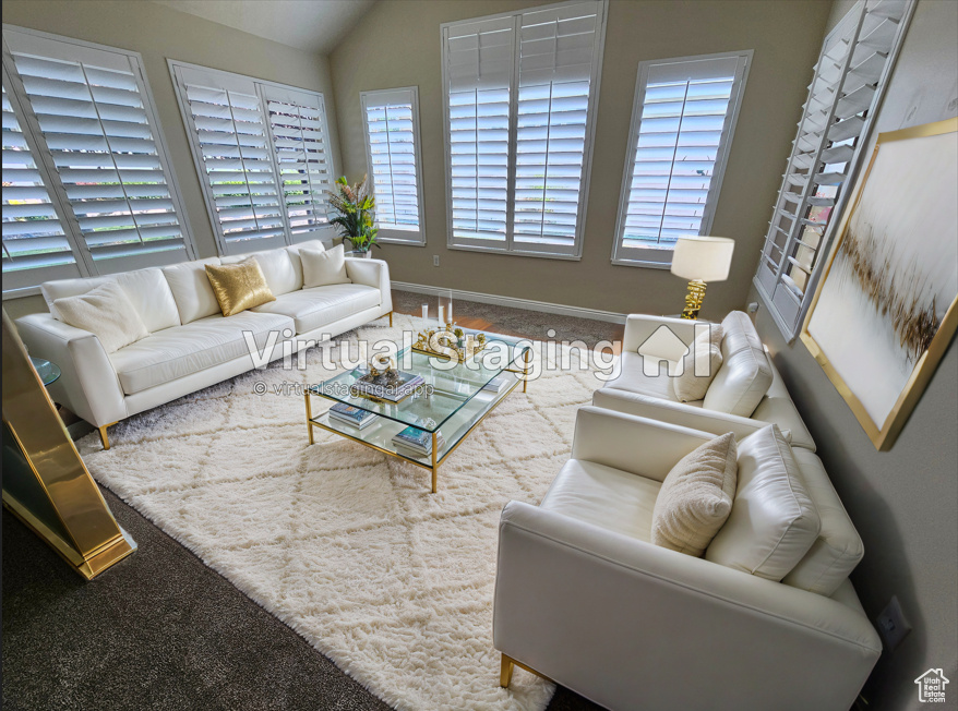 Living room featuring carpet flooring, lofted ceiling, and a wealth of natural light