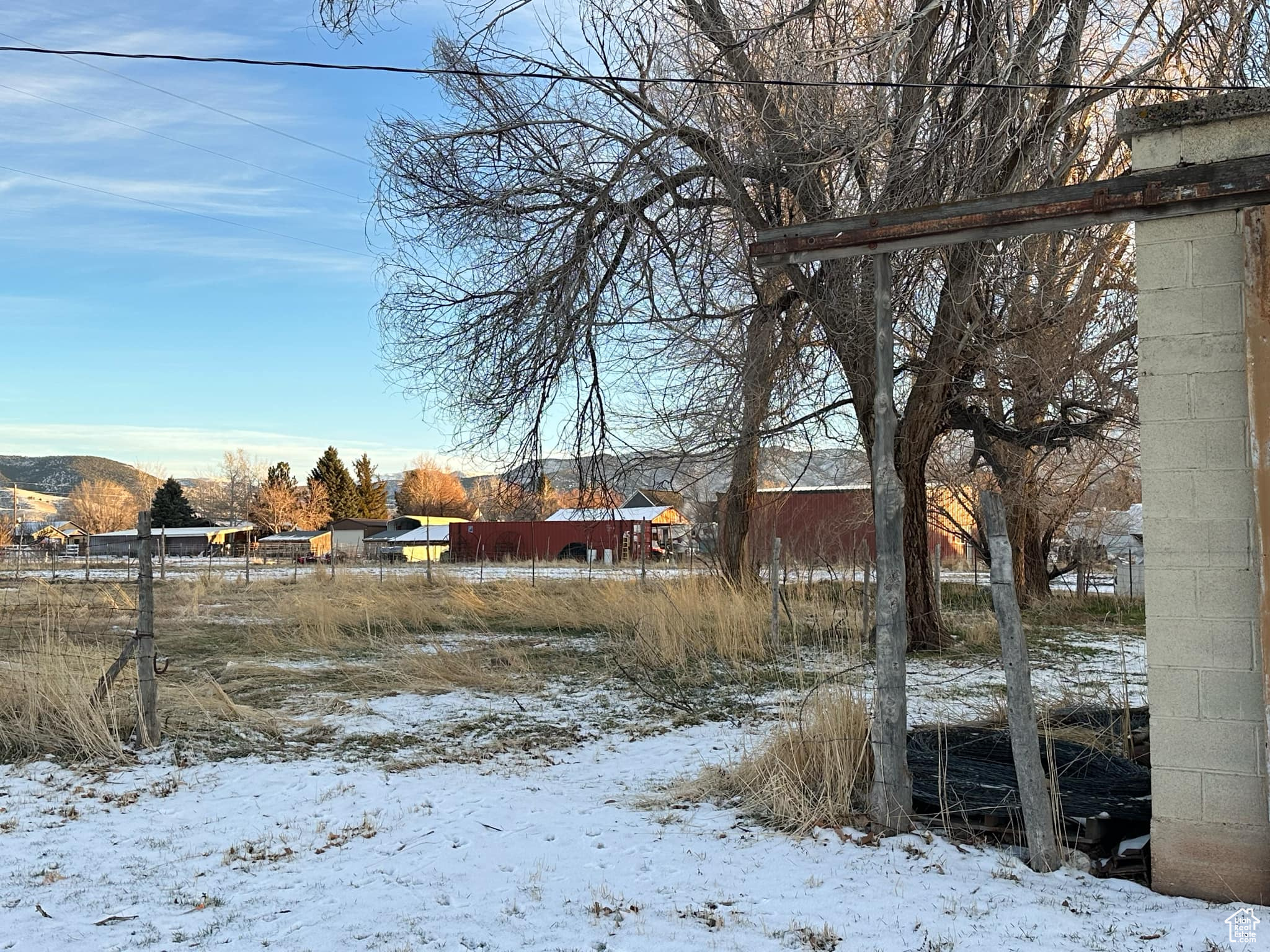 Yard layered in snow featuring a mountain view