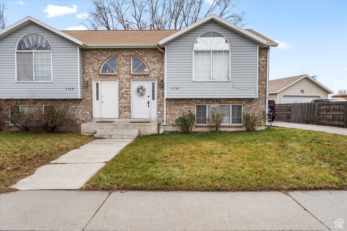 Split foyer home featuring a front lawn