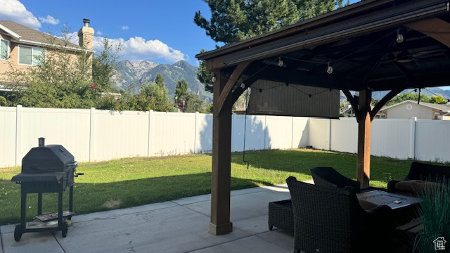 View of patio with a gazebo, a mountain view, and area for grilling