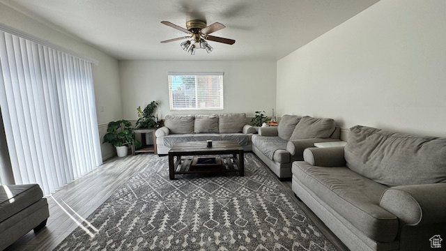 Living room with ceiling fan and wood-type flooring