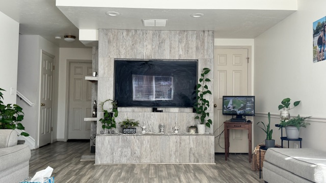 Living room featuring a fireplace and hardwood / wood-style flooring