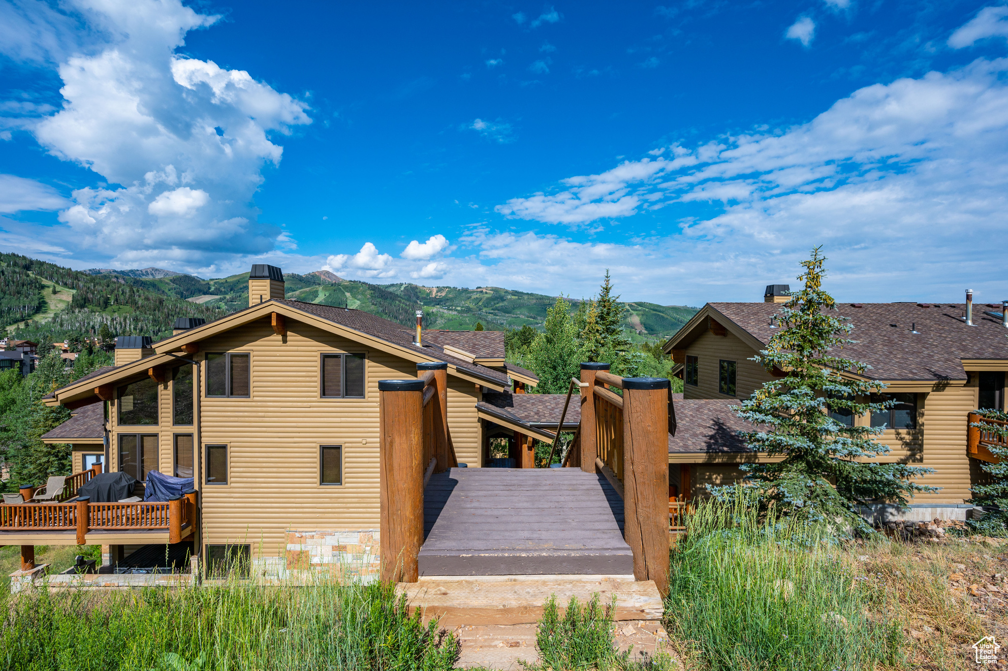 Back of house with a deck with mountain view