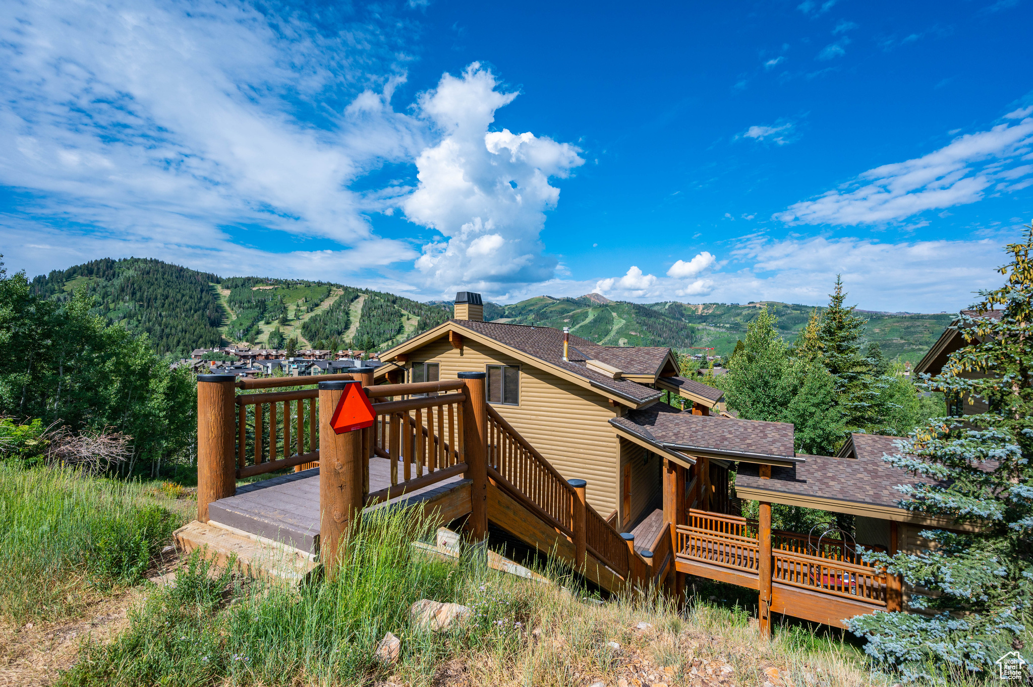 Rear view of property with a deck with mountain view