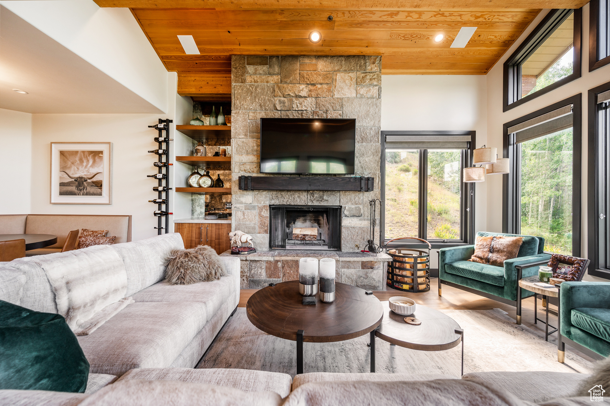 Living room with a fireplace, hardwood / wood-style flooring, vaulted ceiling, and wood ceiling