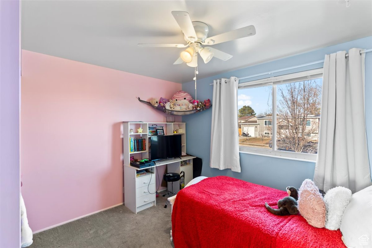 Carpeted upstairs bedroom #2 with ceiling fan