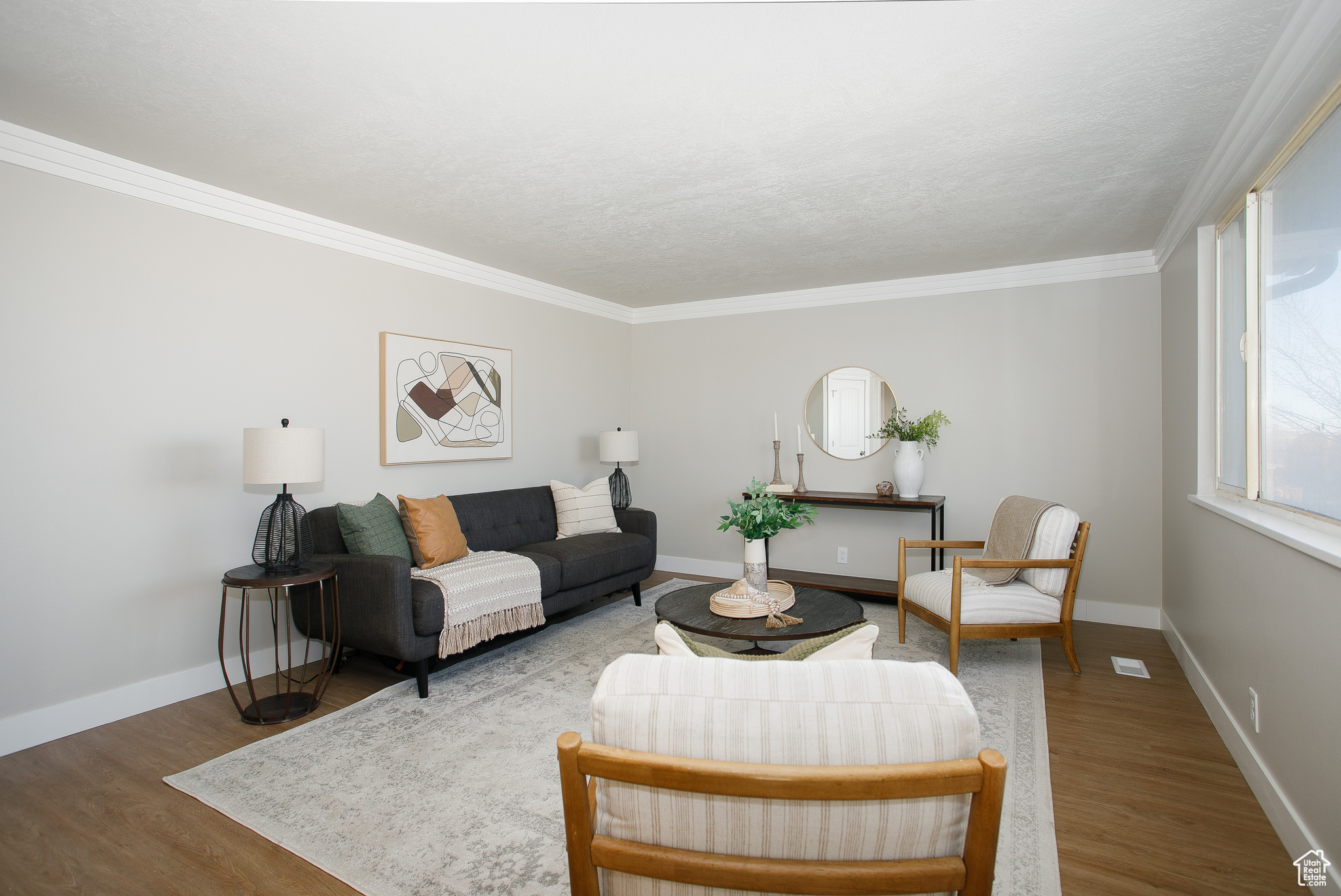 Living room featuring hardwood / wood-style flooring and crown molding