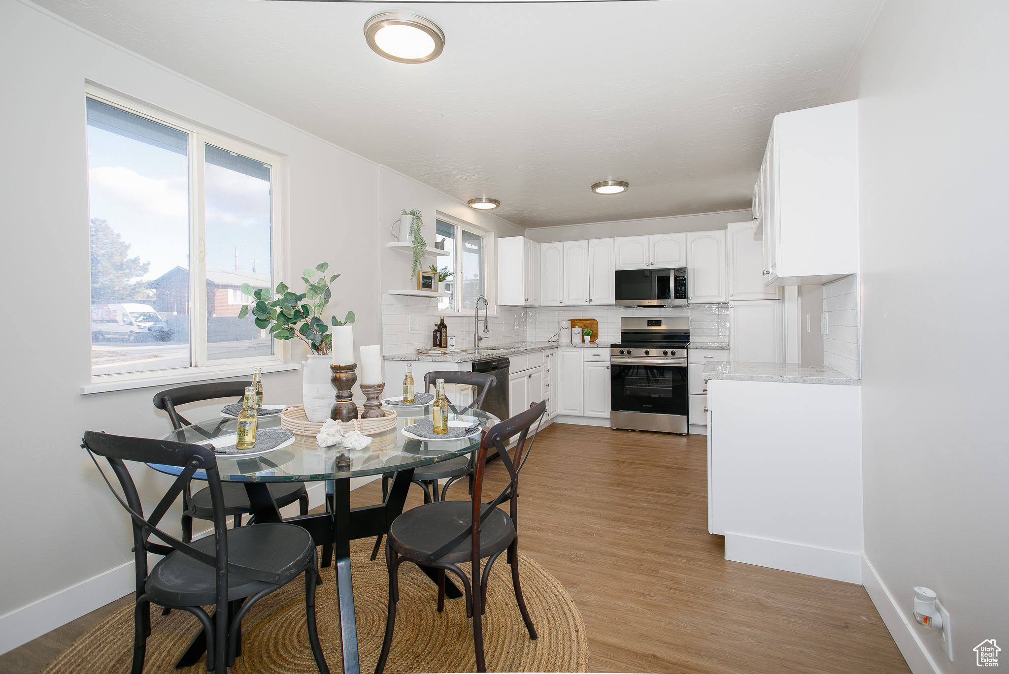 Dining space featuring a wealth of natural light, sink, and light hardwood / wood-style flooring