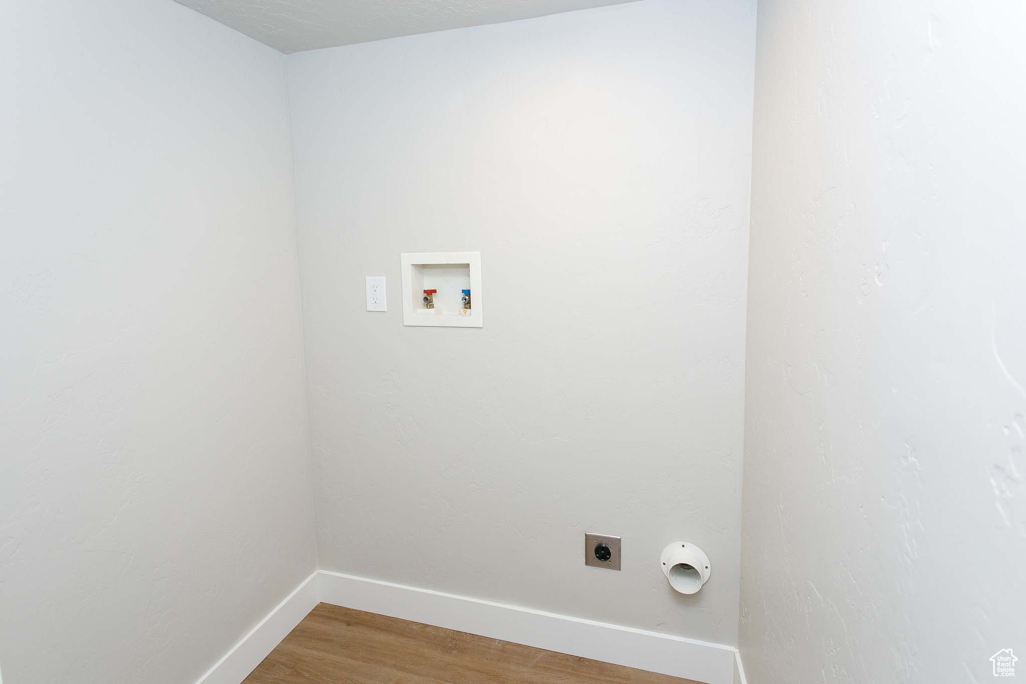 Laundry room with hookup for a washing machine, hardwood / wood-style flooring, and electric dryer hookup