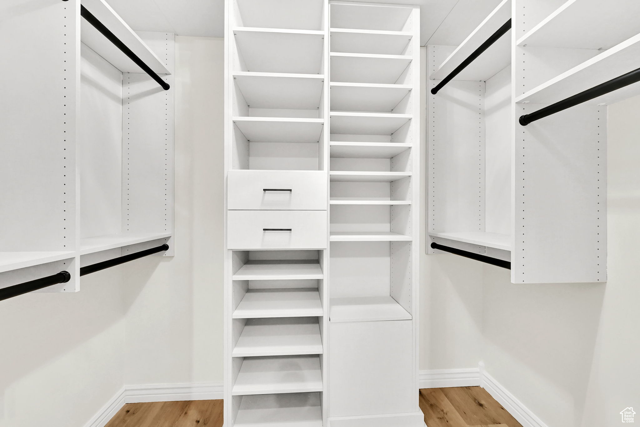 Spacious closet with light hardwood / wood-style floors