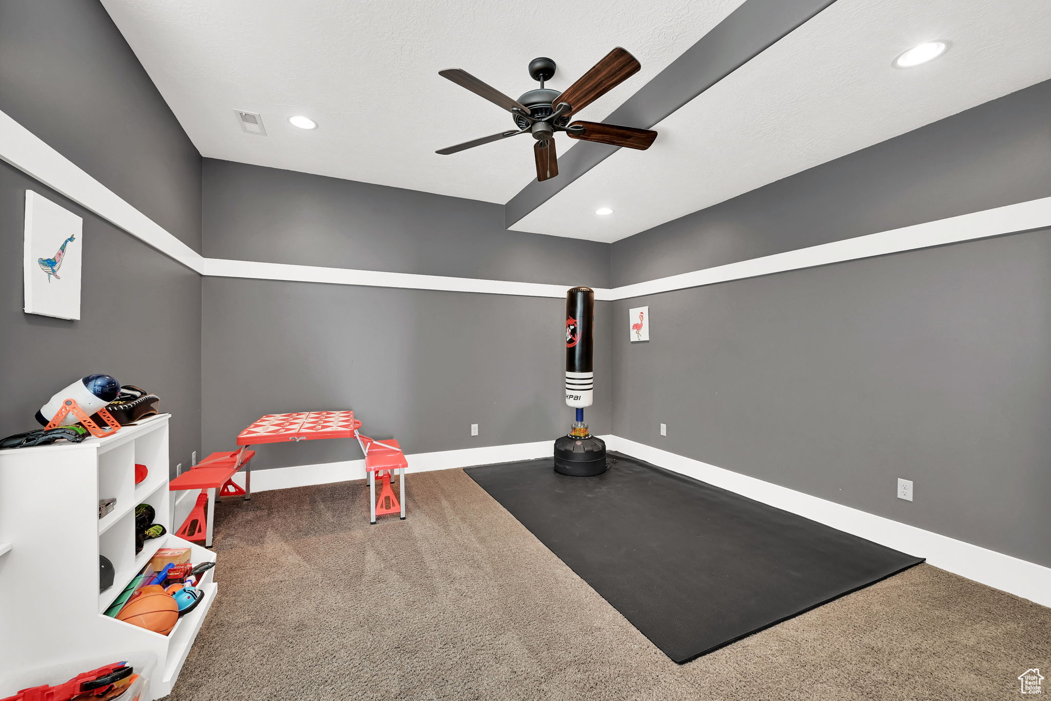 Bedroom with dark carpet and ceiling fan