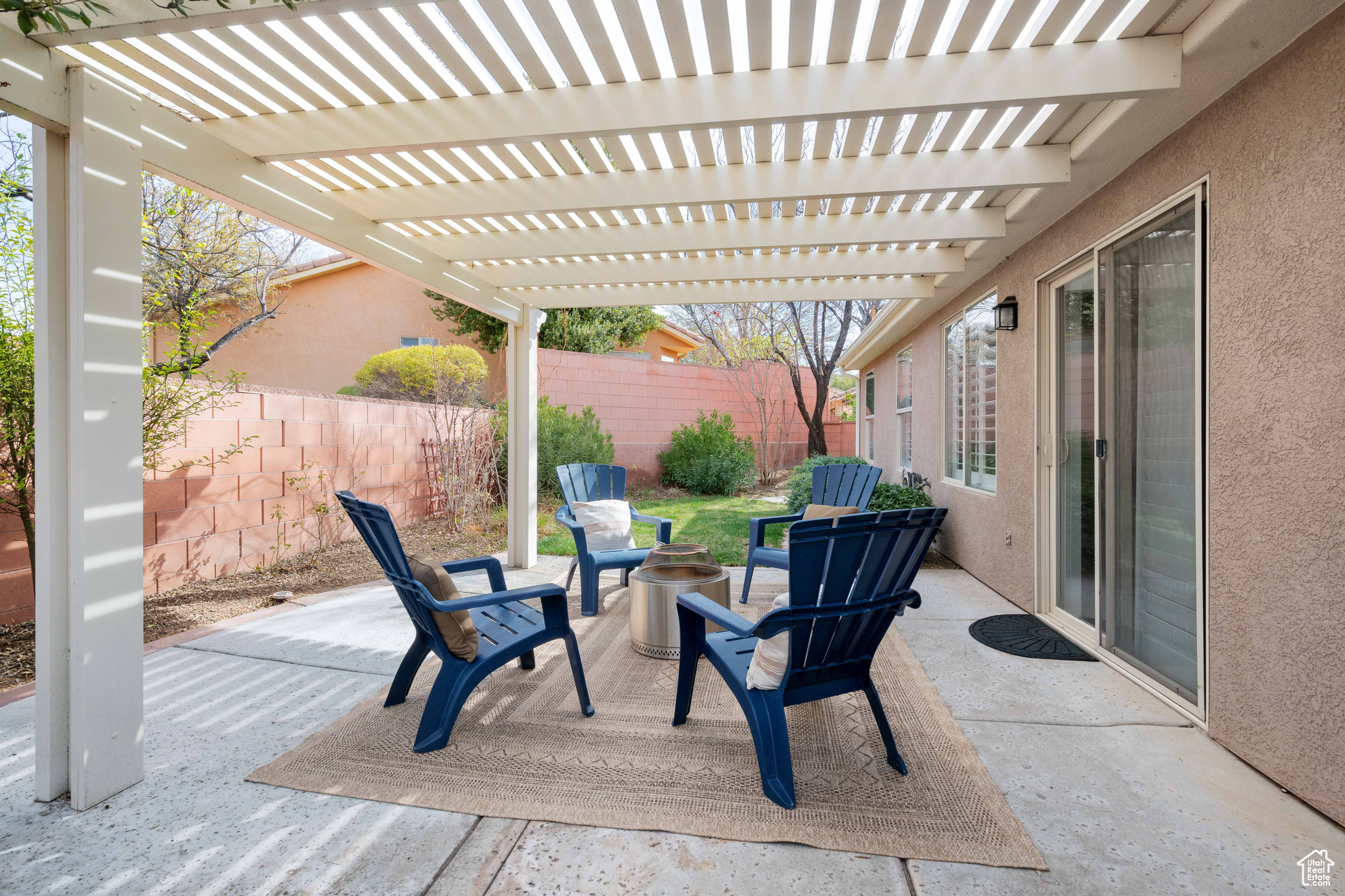 View of patio featuring an outdoor fire pit, a pergola, and fence