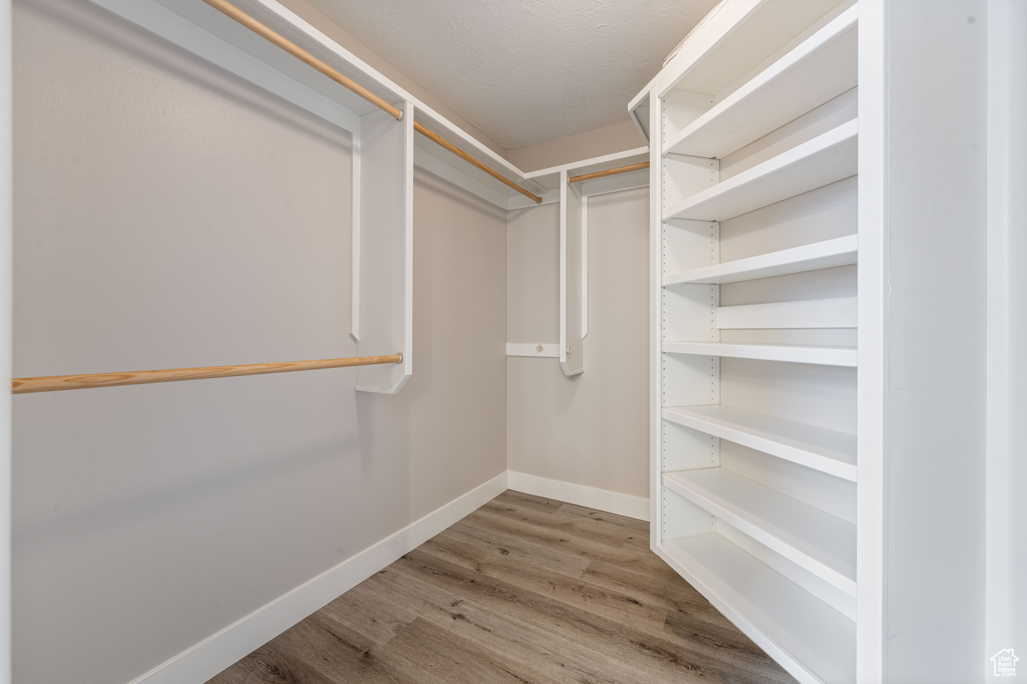 Walk in closet featuring wood finished floors
