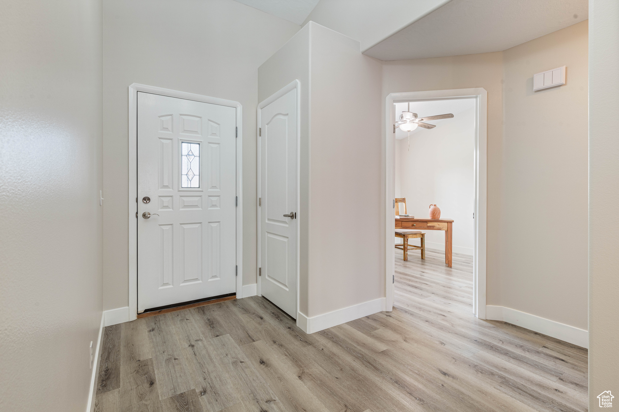 Entrance foyer featuring baseboards and light wood-type flooring