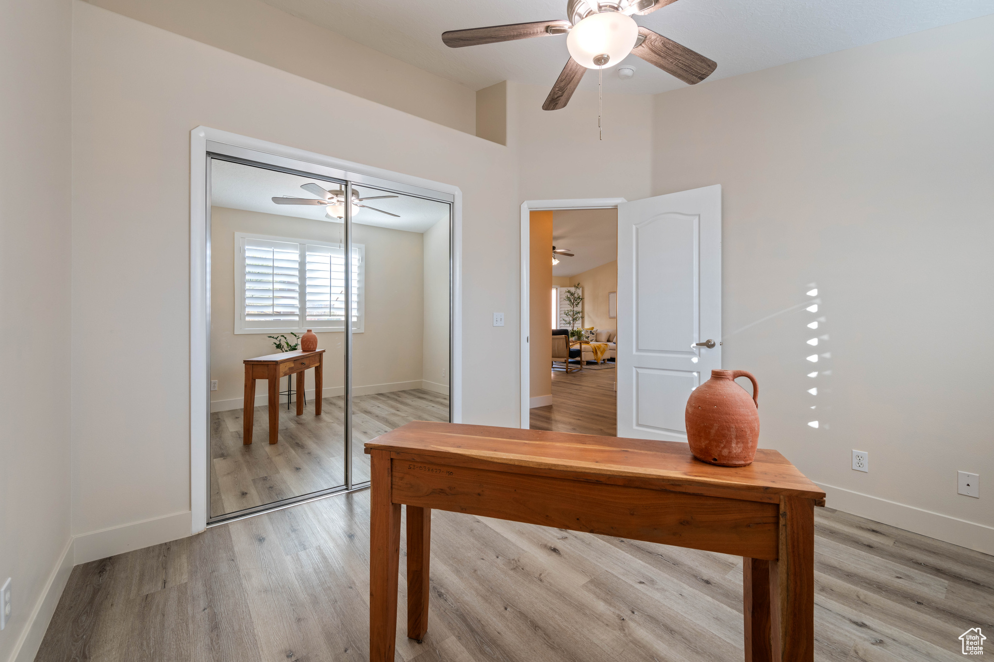 Office featuring ceiling fan and light hardwood / wood-style flooring