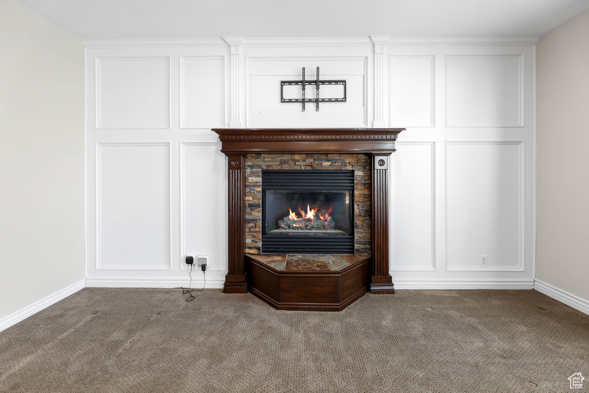 Room details with carpet flooring and a stone fireplace