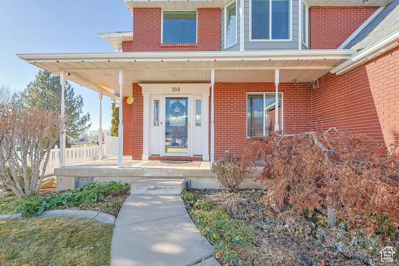 Doorway to property with covered porch
