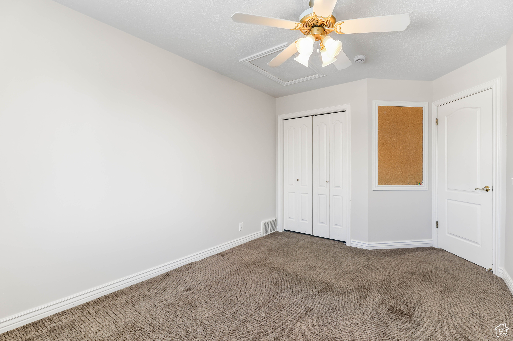 Unfurnished bedroom with carpet flooring, ceiling fan, and a closet