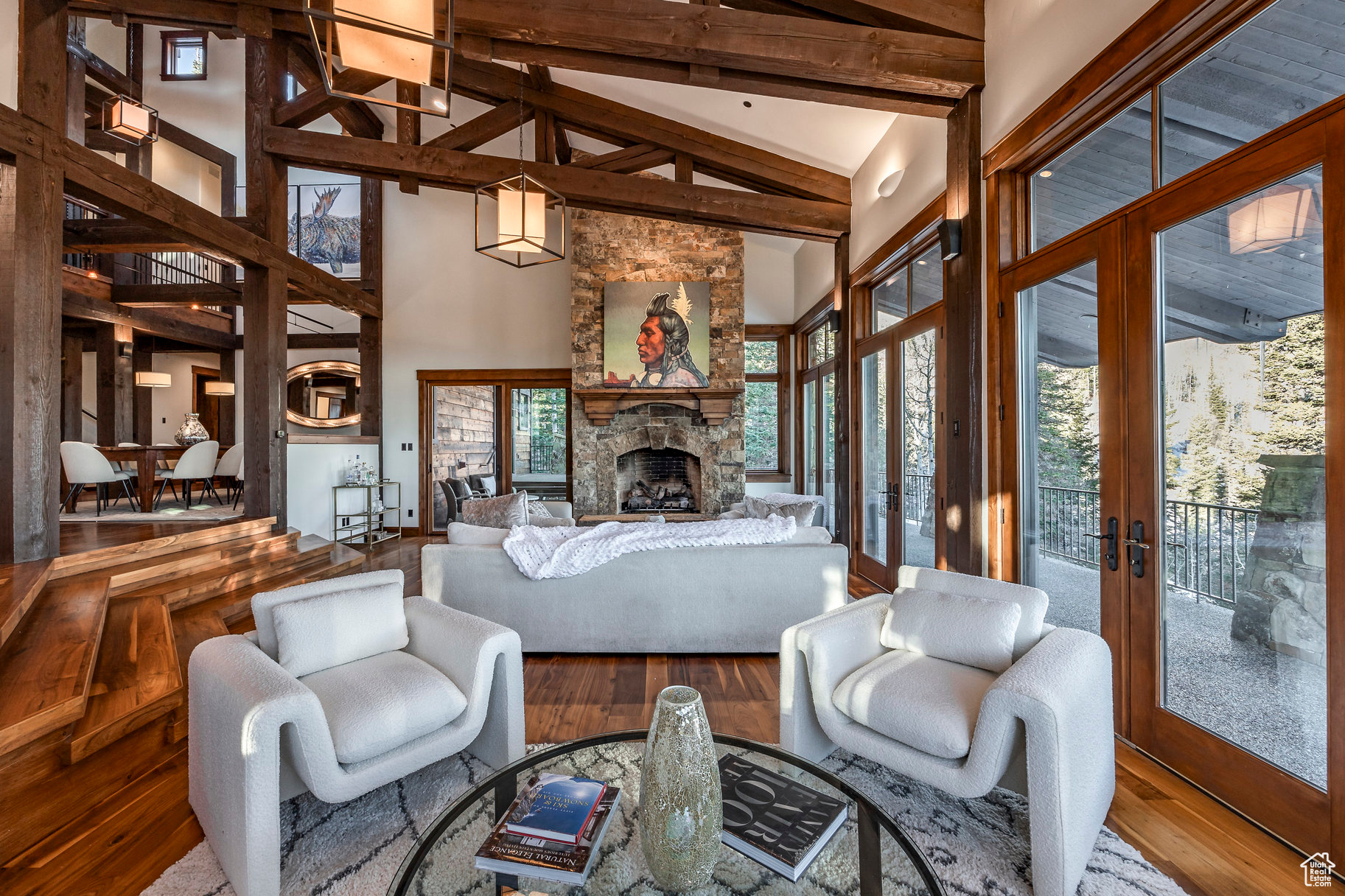 Living room with hardwood / wood-style flooring, a fireplace, high vaulted ceiling, and french doors