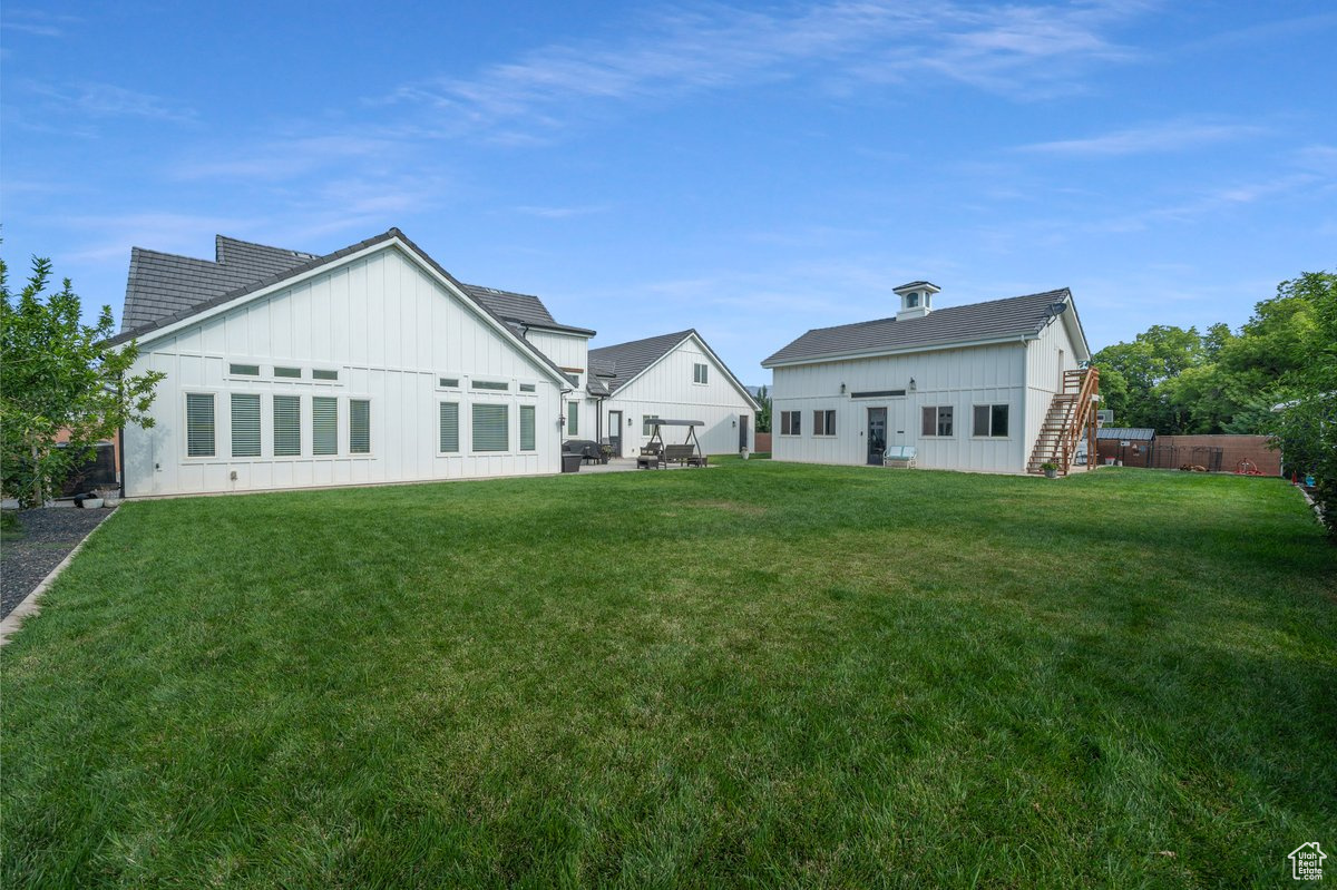 Back of house with a lawn