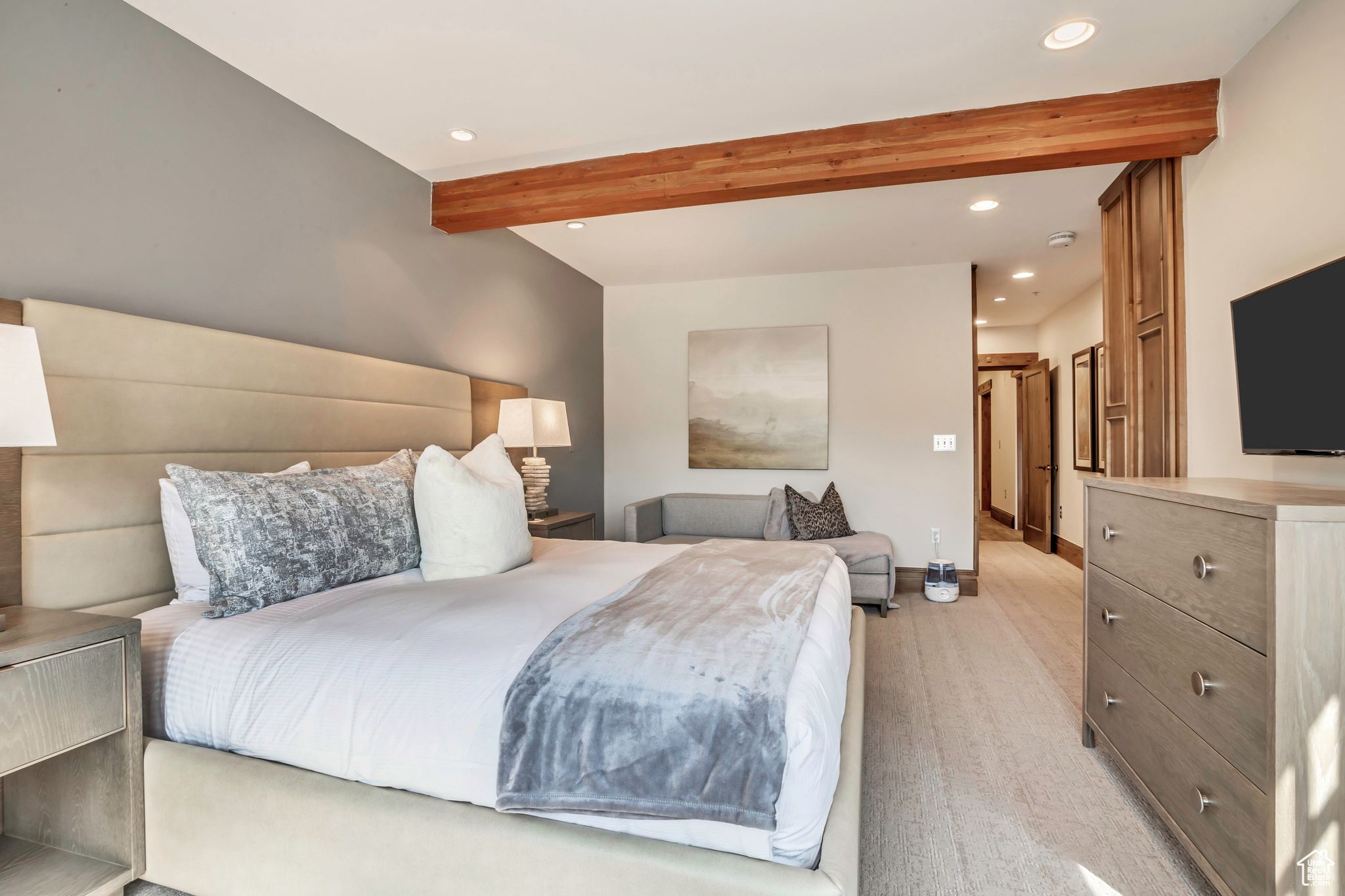 Carpeted bedroom featuring beamed ceiling