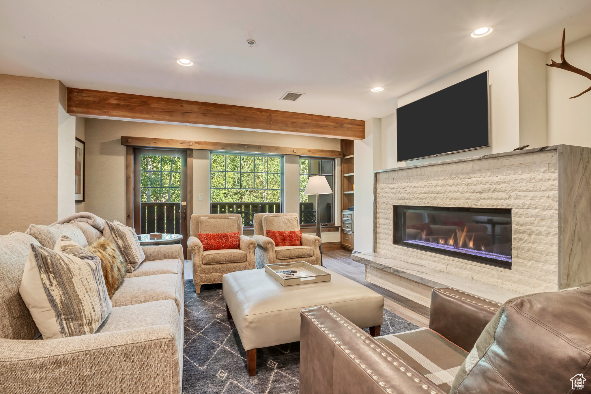 Living room with beam ceiling and a fireplace