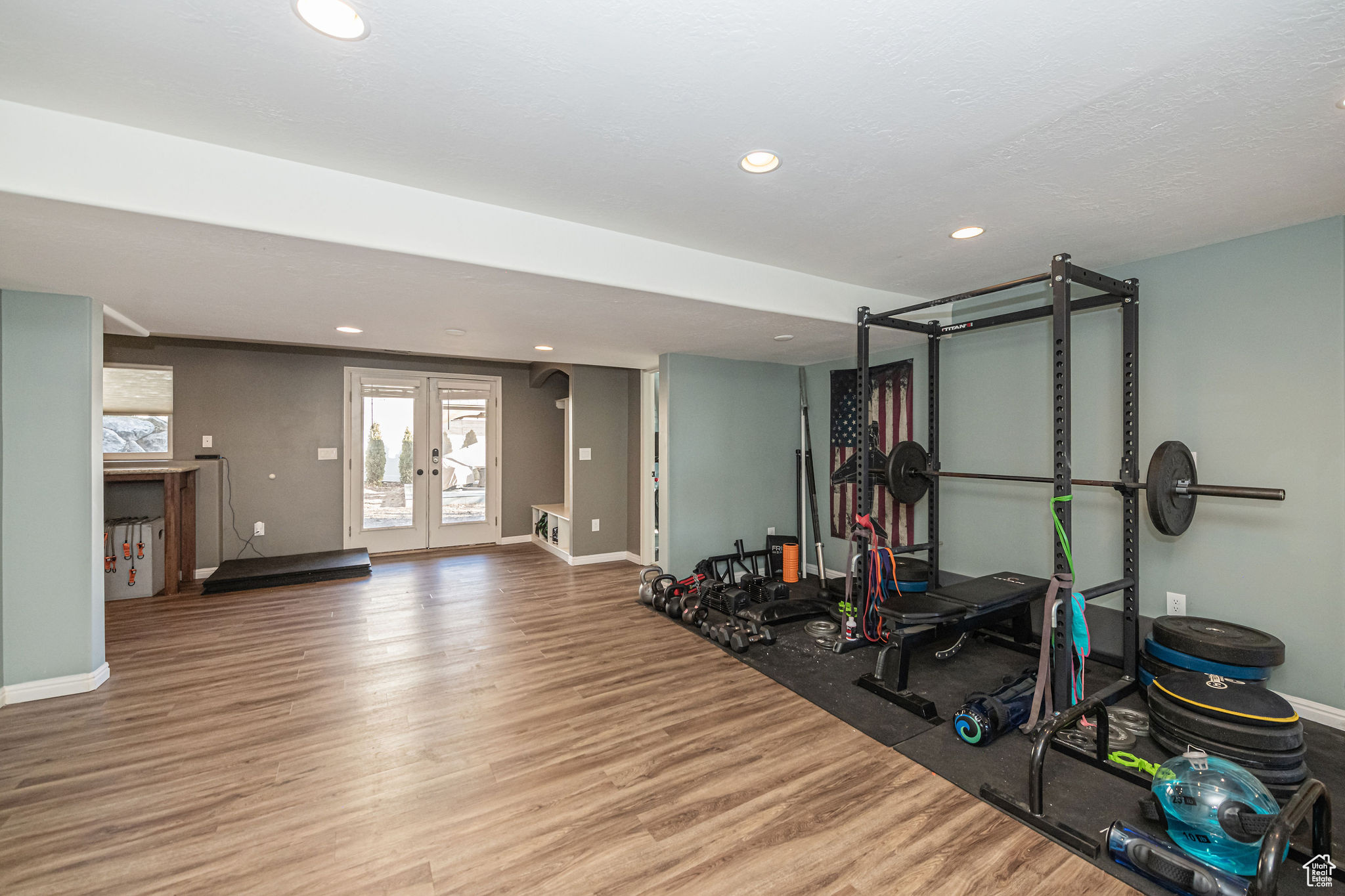 Workout area with hardwood / wood-style flooring and french doors
