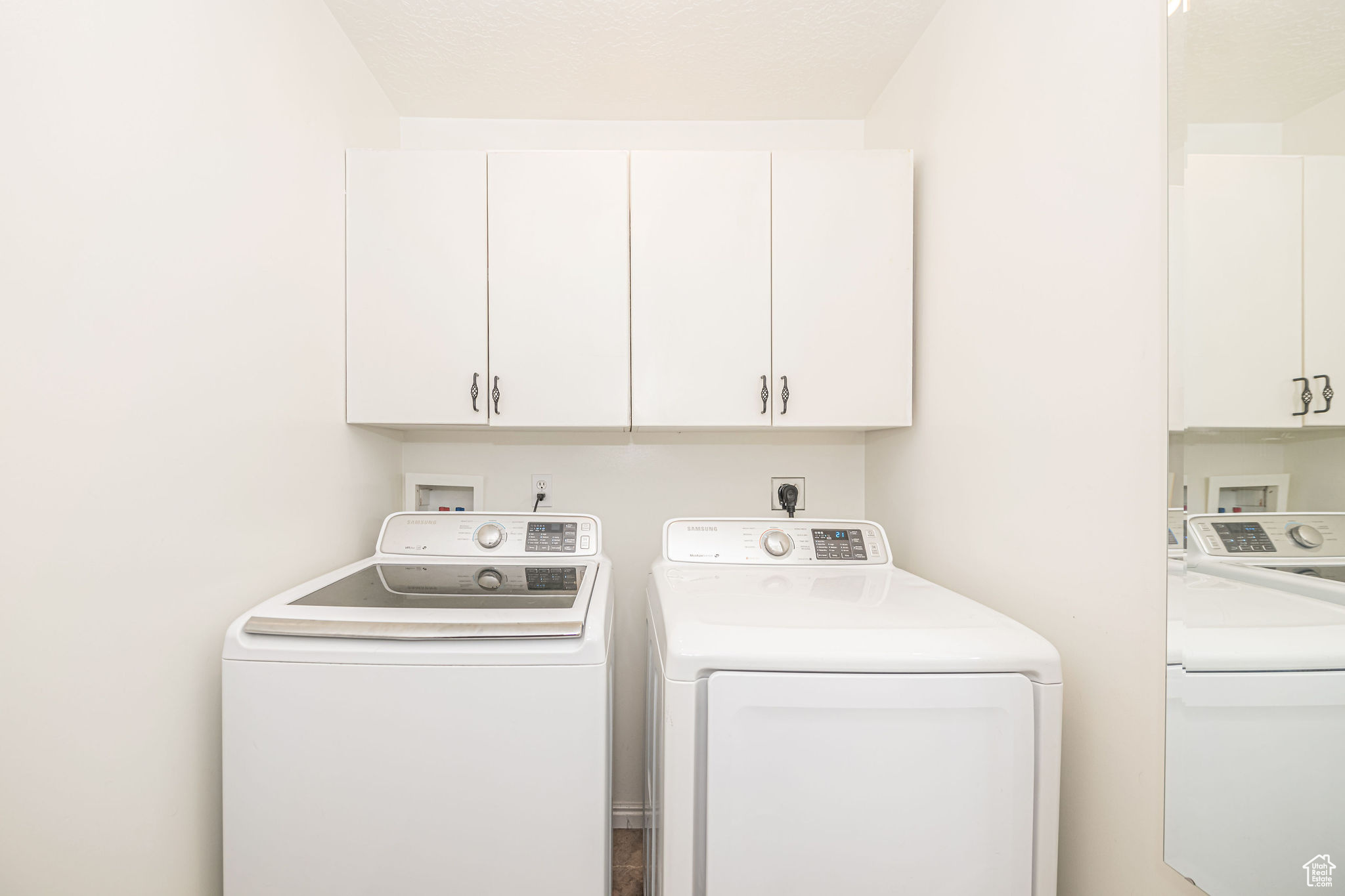 Washroom featuring cabinets and independent washer and dryer