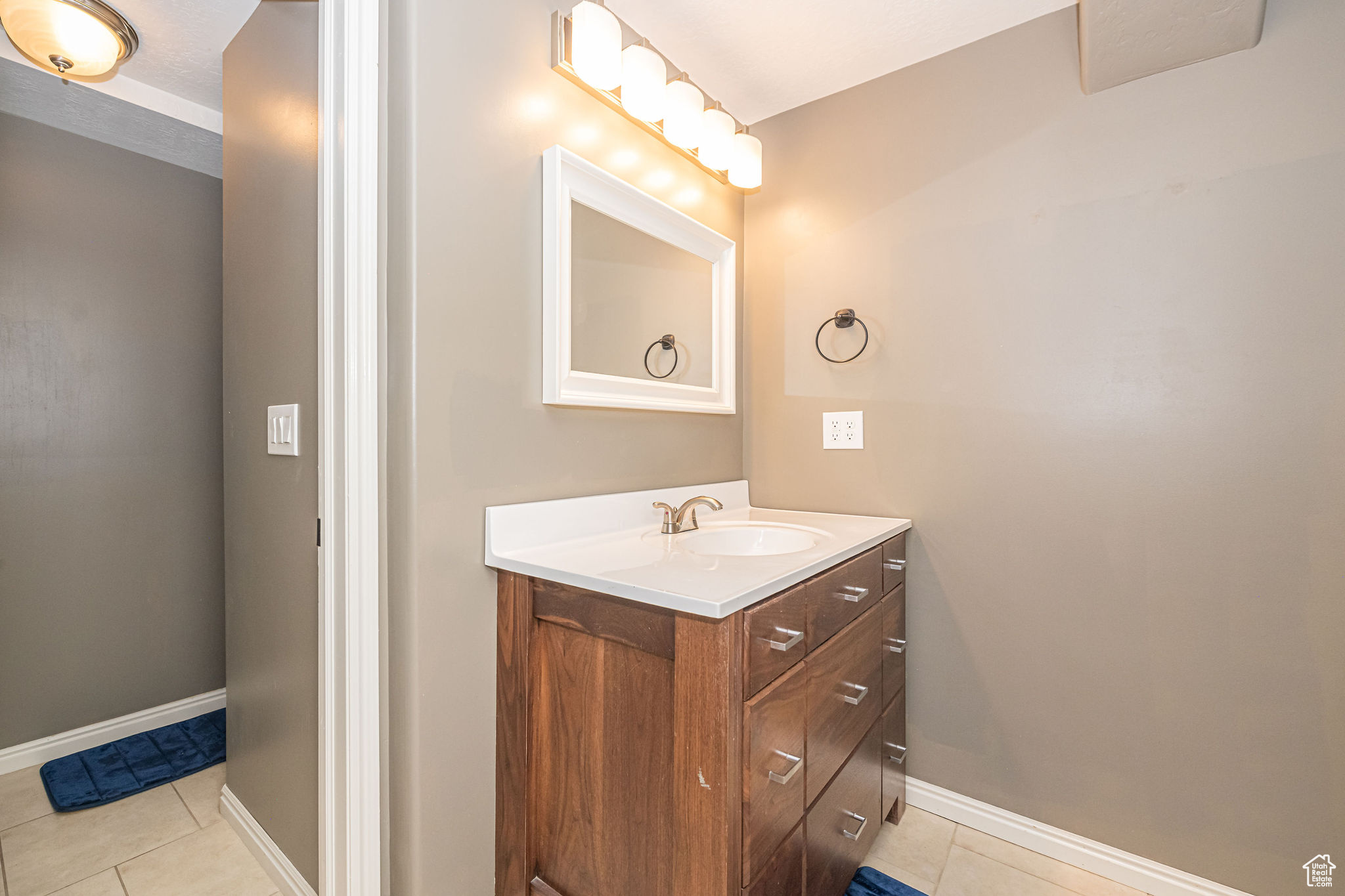 Bathroom featuring tile patterned floors and vanity